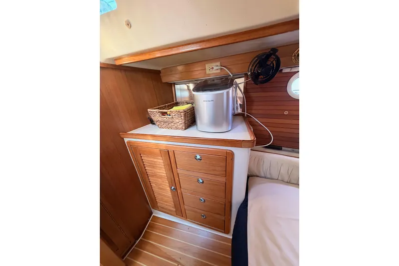 Seaduction Yacht Photos Pics Cozy interior of 2005 Catalina 42 MkII sailboat with wooden cabinetry and compact appliances.