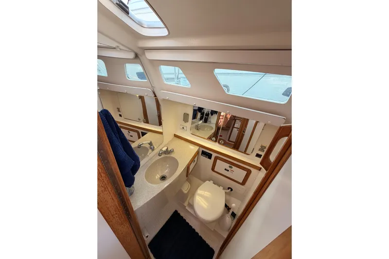 Seaduction Yacht Photos Pics Catalina 42 MkII 2005 yacht bathroom with sink, toilet, and mirror.