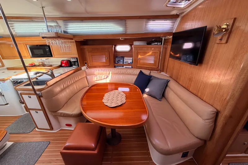 Seaduction Yacht Photos Pics Luxurious 2005 Catalina 42 MkII yacht interior with cozy seating and modern amenities.