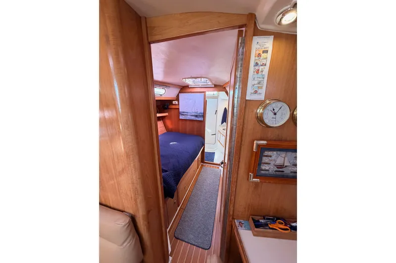Seaduction Yacht Photos Pics Interior of 2005 Catalina 42 MkII sailboat, featuring cozy cabin with wooden finishes.