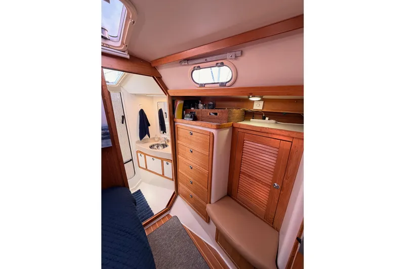 Seaduction Yacht Photos Pics Interior of 2005 Catalina 42 MkII sailboat, featuring wooden cabinetry and compact bathroom.