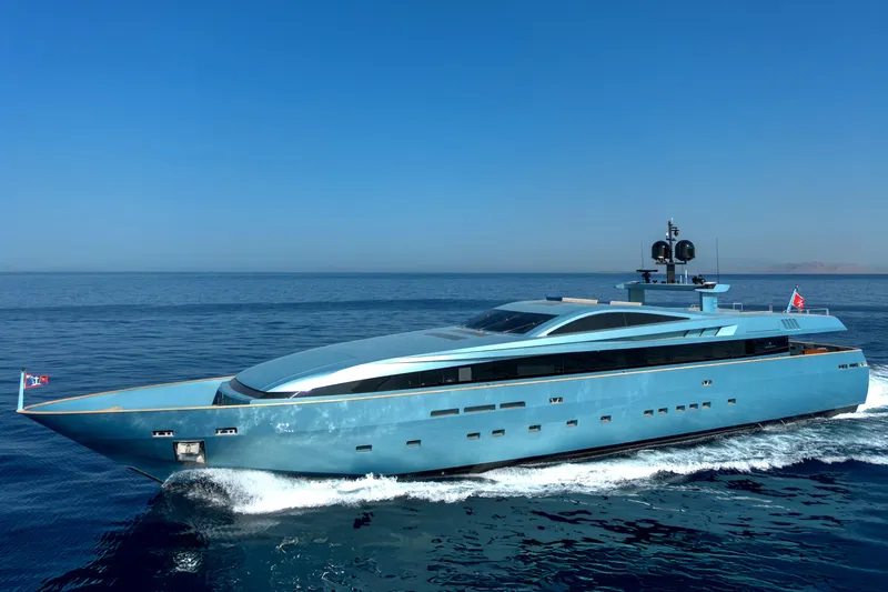 Queen Blue Yacht Photos Pics Luxury 2007 Baglietto 44 Fast yacht cruising on open sea under clear blue sky.