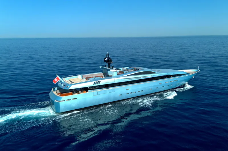 Queen Blue Yacht Photos Pics Luxurious 2007 Baglietto 44 Fast yacht cruising on open sea under clear blue sky.