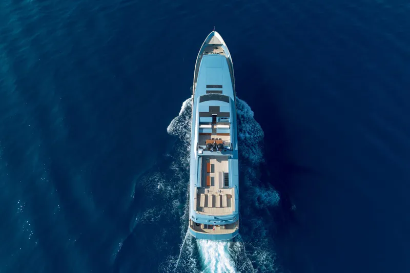 Queen Blue Yacht Photos Pics Aerial view of 2007 Baglietto 44 Fast yacht cruising on deep blue ocean.