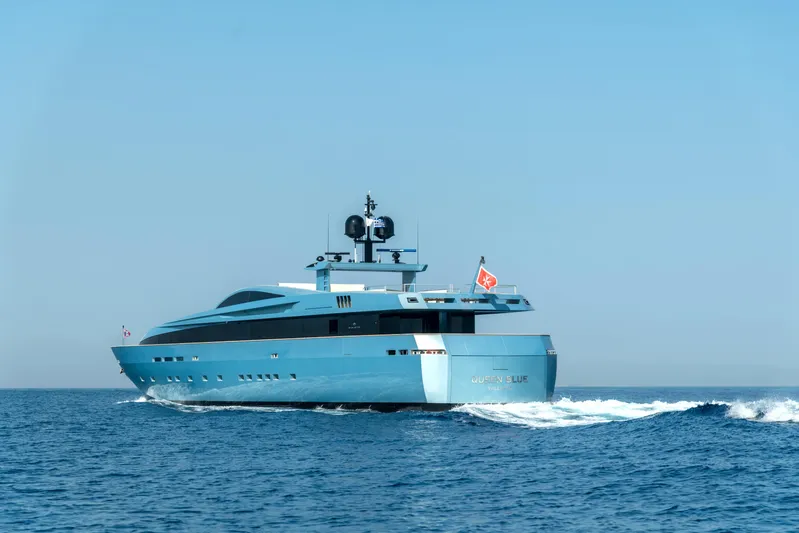 Queen Blue Yacht Photos Pics Luxury 2007 Baglietto 44 Fast yacht cruising on open sea under clear blue sky.