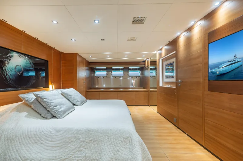 Queen Blue Yacht Photos Pics Luxurious bedroom interior of 2007 Baglietto 44 Fast yacht with wood paneling and modern decor.