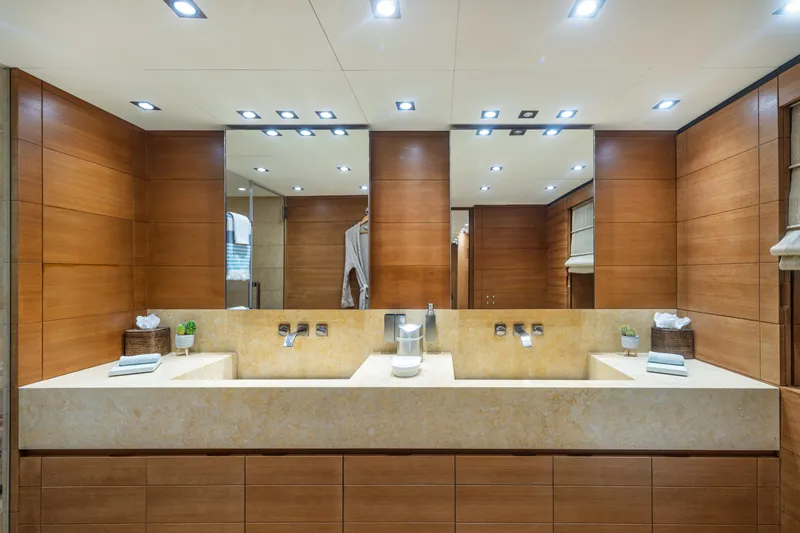 Queen Blue Yacht Photos Pics Luxurious bathroom with dual sinks and wooden accents on a 2007 Baglietto 44 Fast yacht.