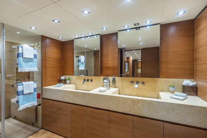 Queen Blue Yacht Photos Pics Luxurious bathroom on 2007 Baglietto 44 Fast yacht with double sinks and modern wood paneling.