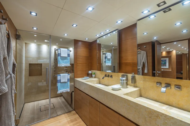 Queen Blue Yacht Photos Pics Luxurious bathroom on 2007 Baglietto 44 Fast yacht, featuring dual sinks and glass shower.