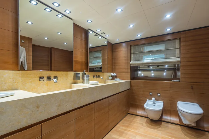 Queen Blue Yacht Photos Pics Luxurious bathroom interior on 2007 Baglietto 44 Fast yacht, featuring modern fixtures and wood paneling.
