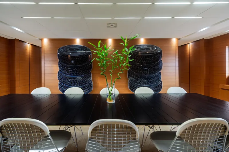 Queen Blue Yacht Photos Pics Luxurious interior of 2007 Baglietto 44 Fast yacht with modern dining area and bamboo centerpiece.