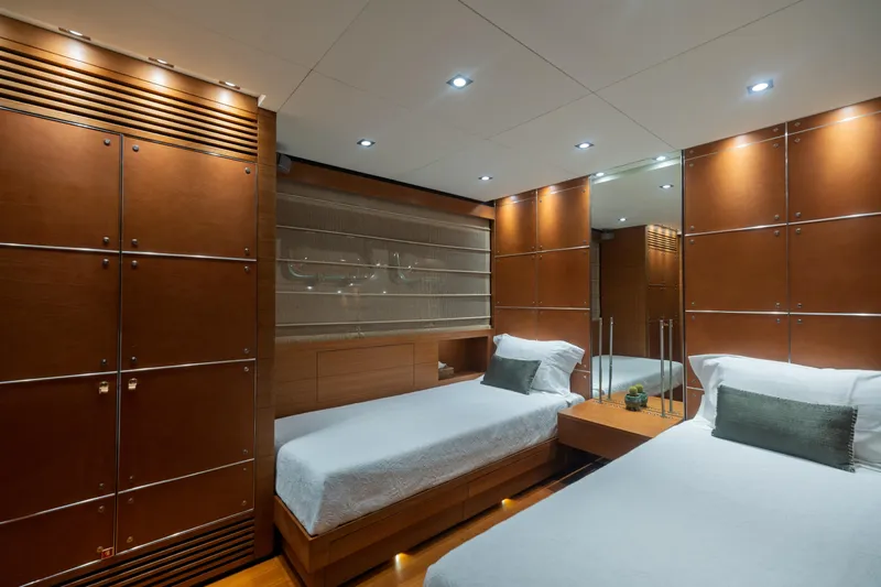 Queen Blue Yacht Photos Pics Luxurious twin cabin interior on 2007 Baglietto 44 Fast yacht, featuring elegant wood paneling.