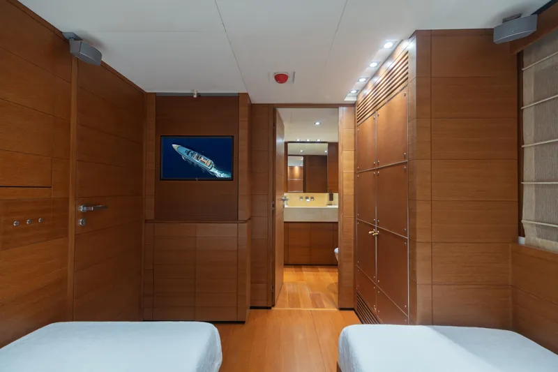 Queen Blue Yacht Photos Pics Luxurious wooden interior of 2007 Baglietto 44 Fast yacht cabin with modern amenities.
