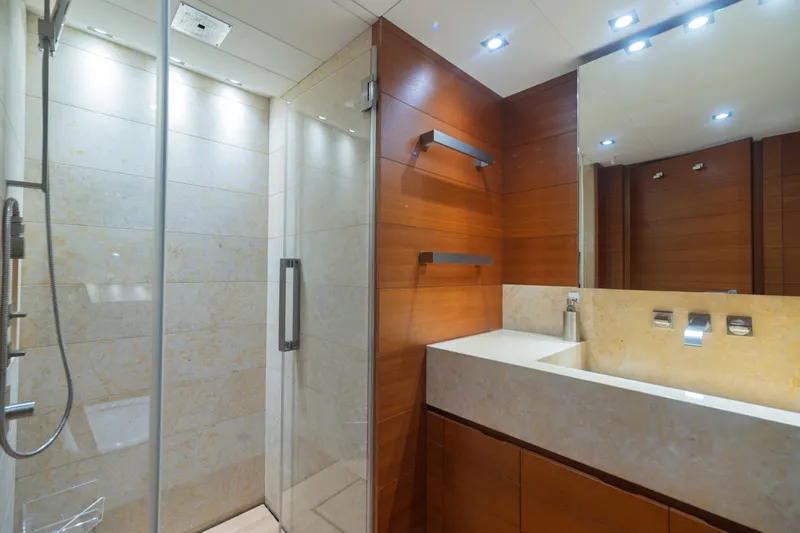 Queen Blue Yacht Photos Pics Luxurious bathroom on 2007 Baglietto 44 Fast yacht with modern shower and elegant wood paneling.