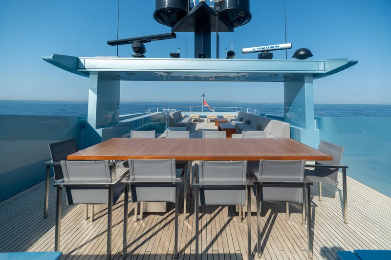 Queen Blue Yacht Photos Pics Luxurious 2007 Baglietto 44 Fast yacht deck with elegant dining area and ocean view.