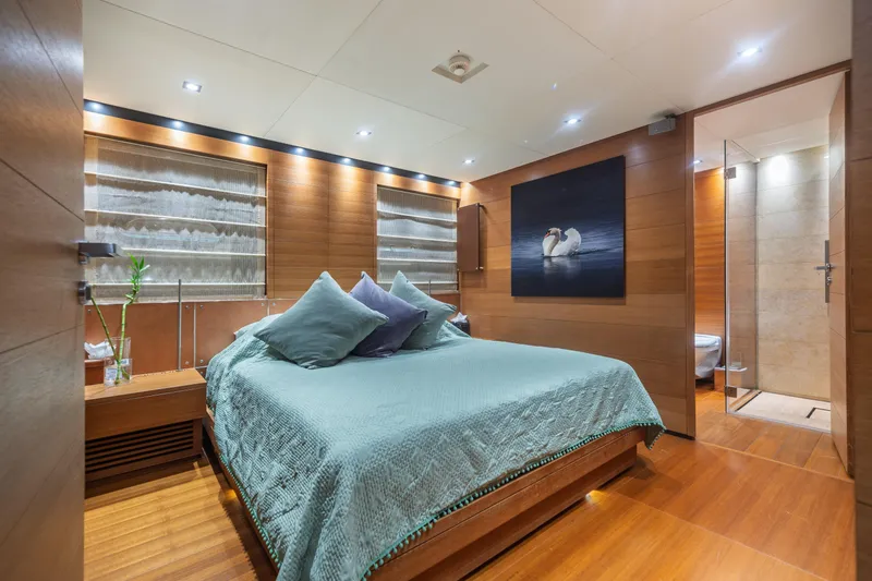 Queen Blue Yacht Photos Pics Luxurious bedroom interior on 2007 Baglietto 44 Fast yacht, featuring elegant wood paneling.