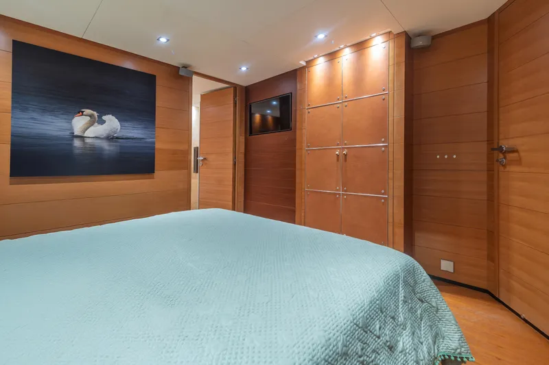 Queen Blue Yacht Photos Pics Luxurious cabin interior of 2007 Baglietto 44 Fast yacht with elegant wood paneling.