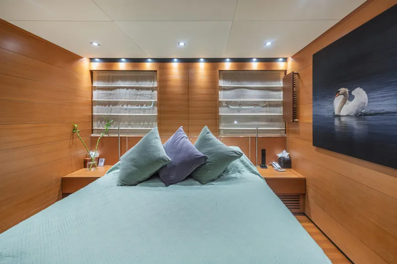 Queen Blue Yacht Photos Pics Luxurious bedroom interior on 2007 Baglietto 44 Fast yacht, featuring elegant wood paneling.