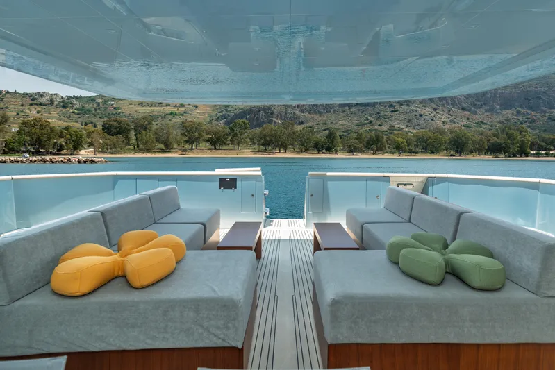 Queen Blue Yacht Photos Pics Luxurious 2007 Baglietto 44 Fast yacht deck with plush seating and scenic water view.