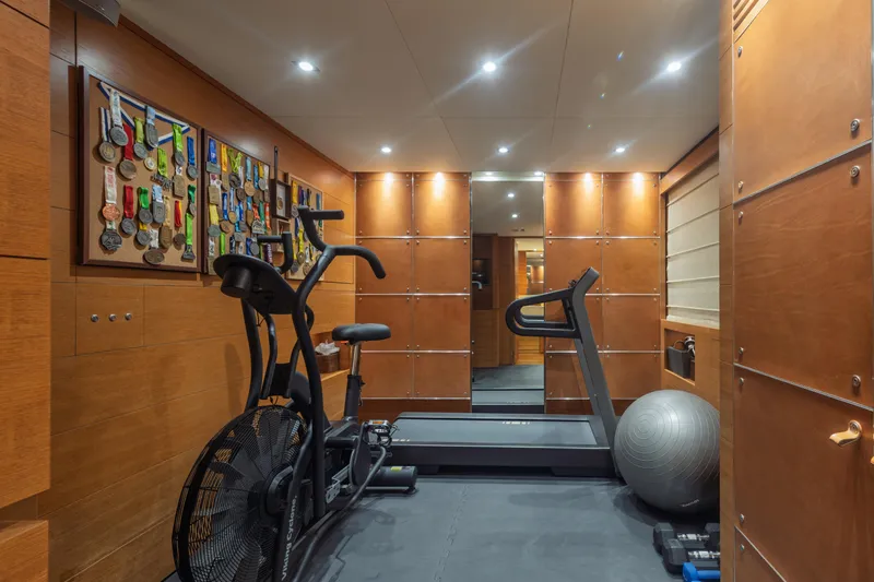 Queen Blue Yacht Photos Pics Luxury yacht gym with exercise bike, treadmill, and medal display on Baglietto 44 Fast, 2007.