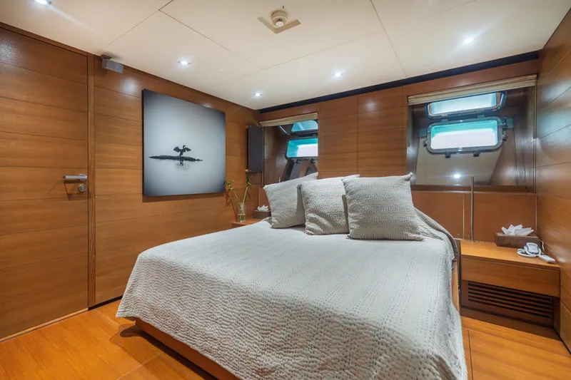 Queen Blue Yacht Photos Pics Luxurious cabin interior of 2007 Baglietto 44 Fast yacht with elegant wood paneling.