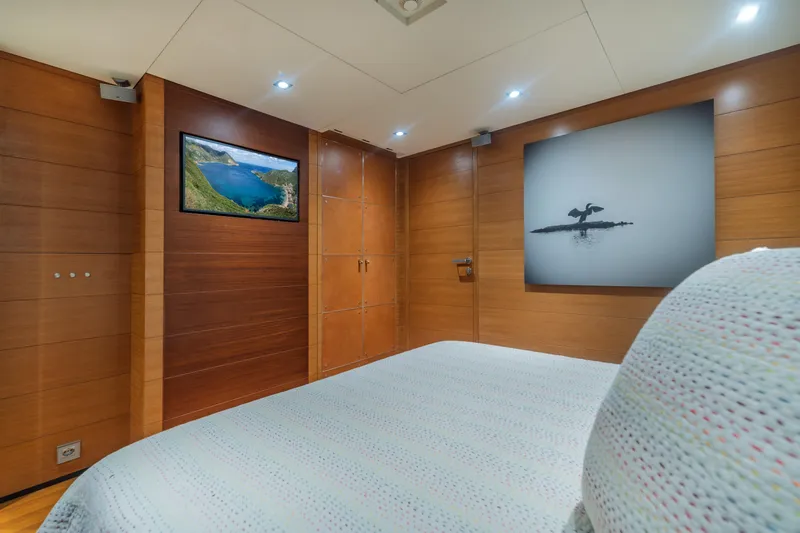 Queen Blue Yacht Photos Pics Luxurious cabin interior of 2007 Baglietto 44 Fast yacht with elegant wood paneling.