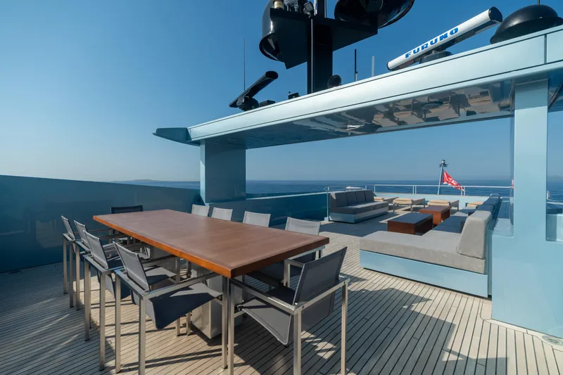 Queen Blue Yacht Photos Pics Luxurious deck of 2007 Baglietto 44 Fast yacht with modern seating and dining area.