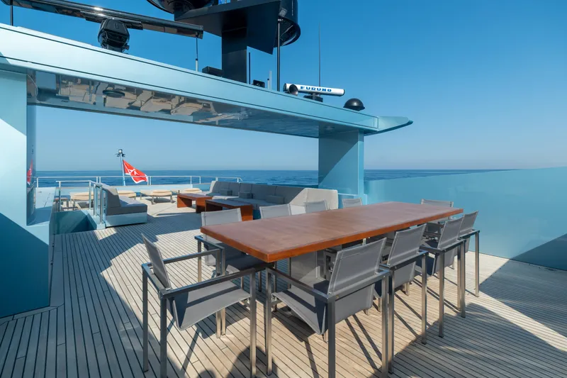 Queen Blue Yacht Photos Pics Luxurious 2007 Baglietto 44 Fast yacht deck with dining area and ocean view.