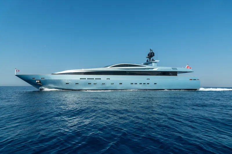 Queen Blue Yacht Photos Pics Luxury 2007 Baglietto 44 Fast yacht cruising on open sea under clear blue sky.