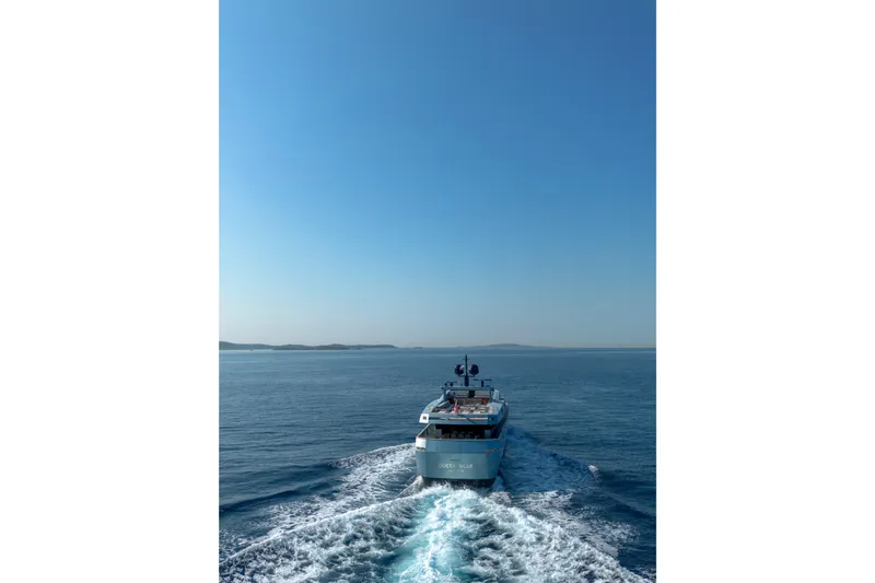 Queen Blue Yacht Photos Pics Baglietto 44 Fast yacht cruising on open sea, 2007 model, under clear blue sky.