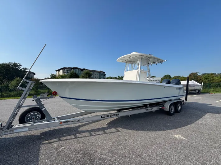  Yacht Photos Pics 2012 Contender 28 Sport boat on trailer, parked outdoors under clear blue sky.