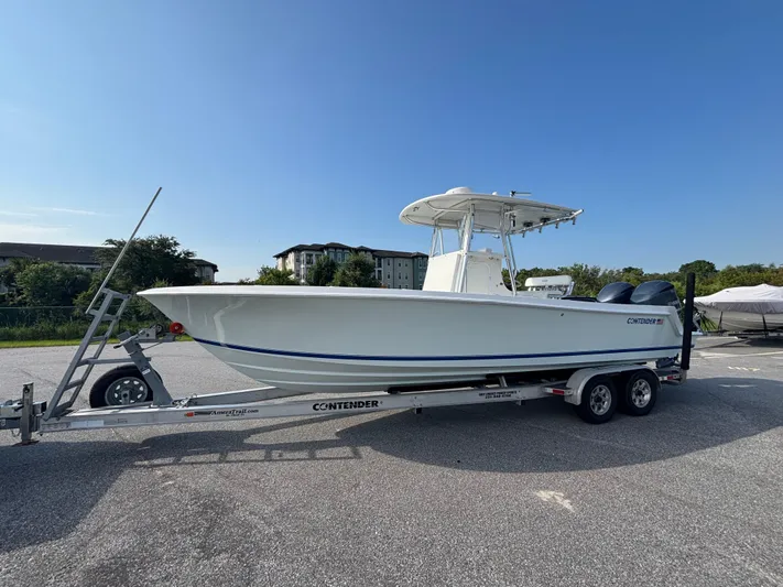  Yacht Photos Pics 2012 Contender 28 Sport boat on trailer, parked outdoors under clear blue sky.