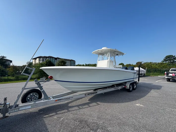  Yacht Photos Pics 2012 Contender 28 Sport boat on trailer in parking lot under clear blue sky.