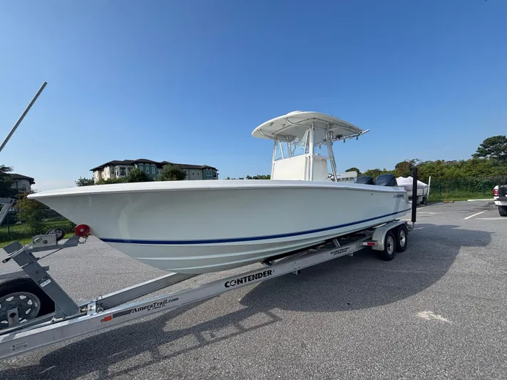  Yacht Photos Pics 2012 Contender 28 Sport boat on trailer in parking lot under clear blue sky.
