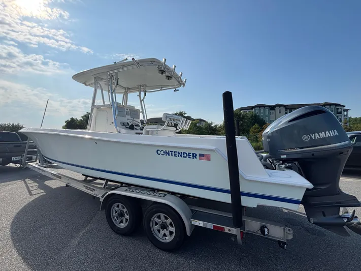  Yacht Photos Pics 2012 Contender 28 Sport boat on trailer with Yamaha engine, parked outdoors.