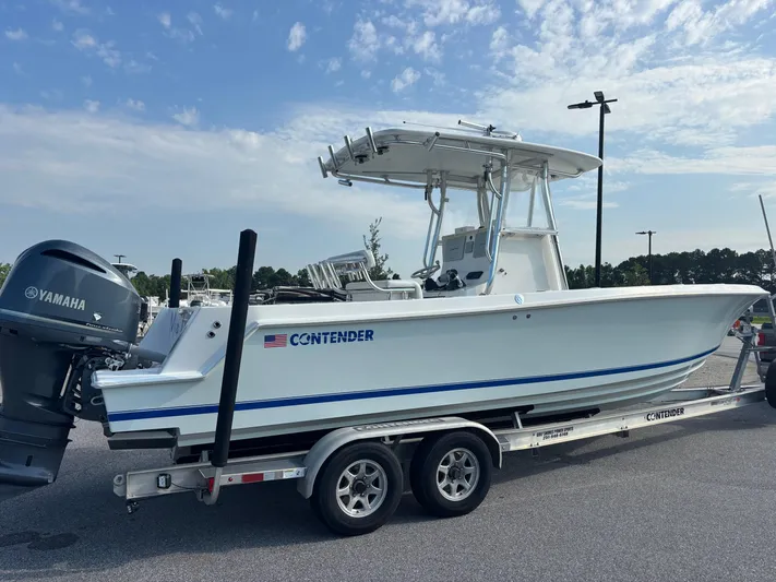  Yacht Photos Pics 2012 Contender 28 Sport boat on trailer with Yamaha engine, parked outdoors.