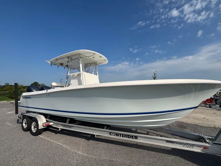  Yacht Photos Pics 2012 Contender 28 Sport boat on trailer under clear blue sky.