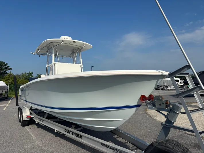  Yacht Photos Pics 2012 Contender 28 Sport boat on trailer under clear blue sky.