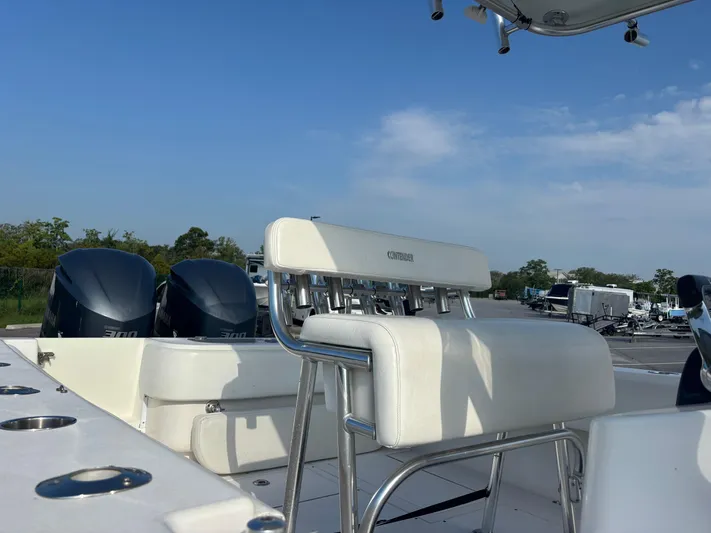  Yacht Photos Pics 2012 Contender 28 Sport boat with dual engines and white seating under a clear sky.