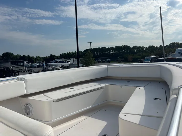  Yacht Photos Pics 2012 Contender 28 Sport boat interior with white seating under a clear sky.
