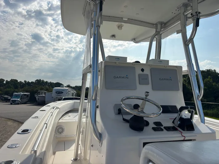  Yacht Photos Pics 2012 Contender 28 Sport boat with Garmin navigation, docked under a cloudy sky.