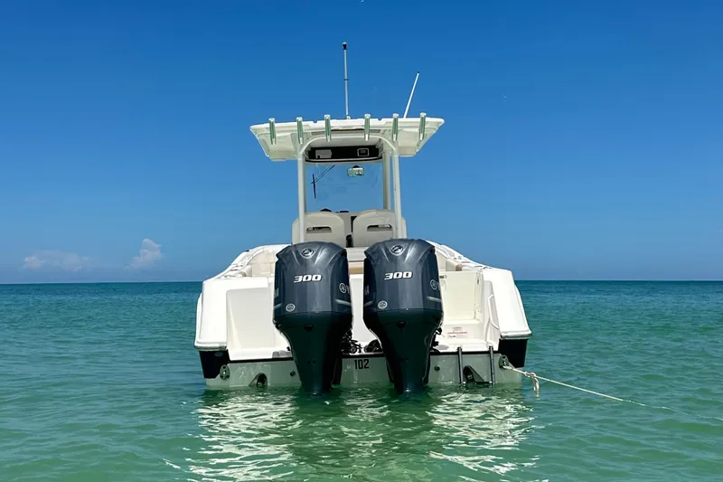  Yacht Photos Pics Edgewater 280CC 2016 boat with dual 300 horsepower engines in clear blue water.