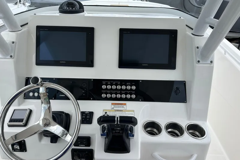  Yacht Photos Pics 2016 Edgewater 280CC boat dashboard with dual Garmin screens and steering wheel.