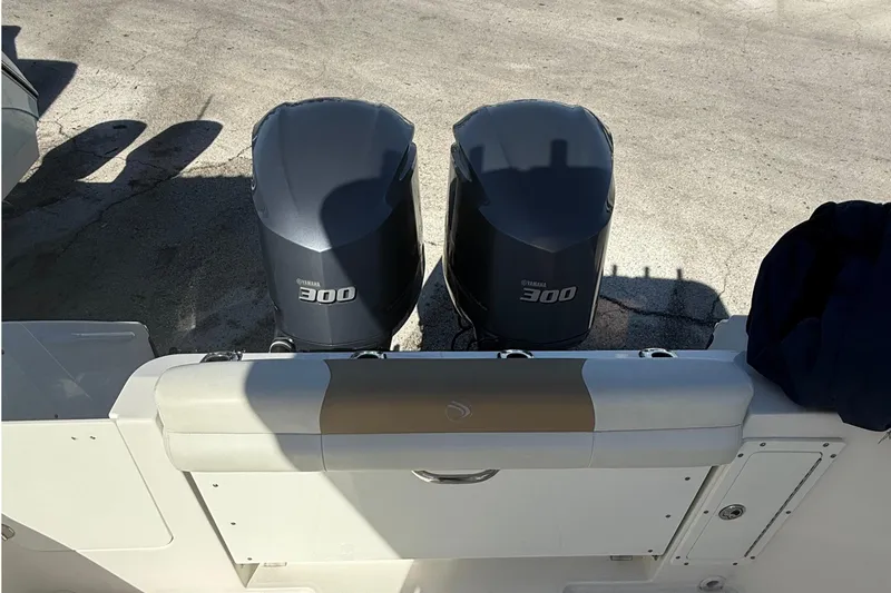  Yacht Photos Pics 2016 Edgewater 280CC boat with dual Yamaha 300 engines, docked on concrete surface.