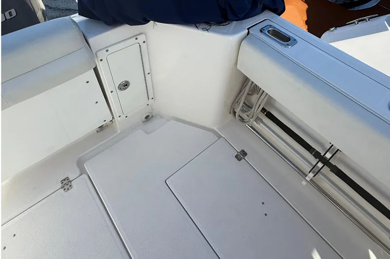  Yacht Photos Pics 2016 Edgewater 280CC boat interior, featuring storage compartments and seating area.
