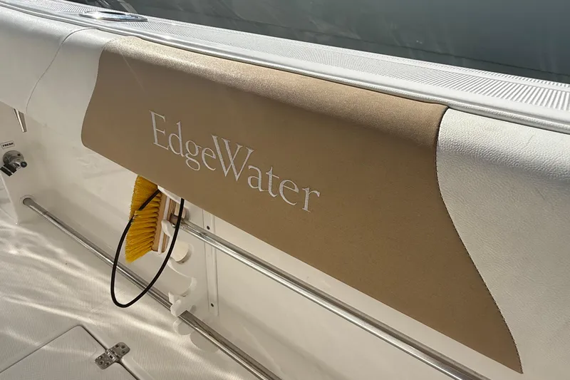  Yacht Photos Pics Edgewater 280CC boat interior detail, featuring branded upholstery and cleaning brush.