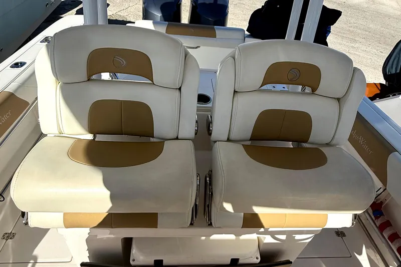  Yacht Photos Pics 2016 Edgewater 280CC boat seats with beige and tan upholstery, showcasing comfort and style.