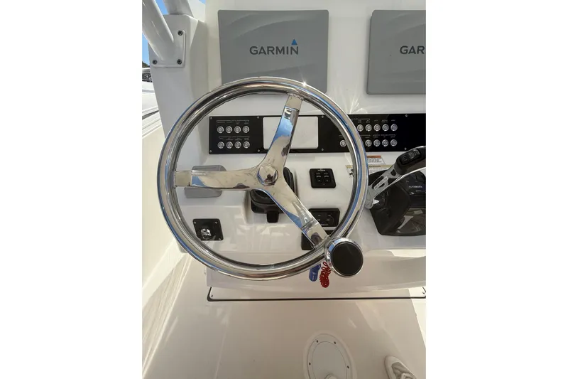  Yacht Photos Pics Steering wheel and controls of 2016 Edgewater 280CC boat with Garmin displays.