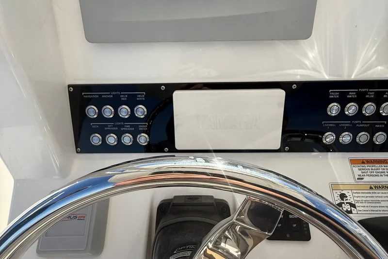  Yacht Photos Pics Control panel of a 2016 Edgewater 280CC boat with steering wheel and switches.