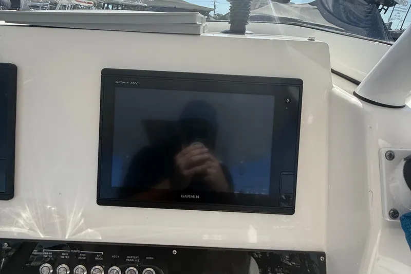  Yacht Photos Pics Garmin GPS display on 2016 Edgewater 280CC boat dashboard, reflecting sunlight.